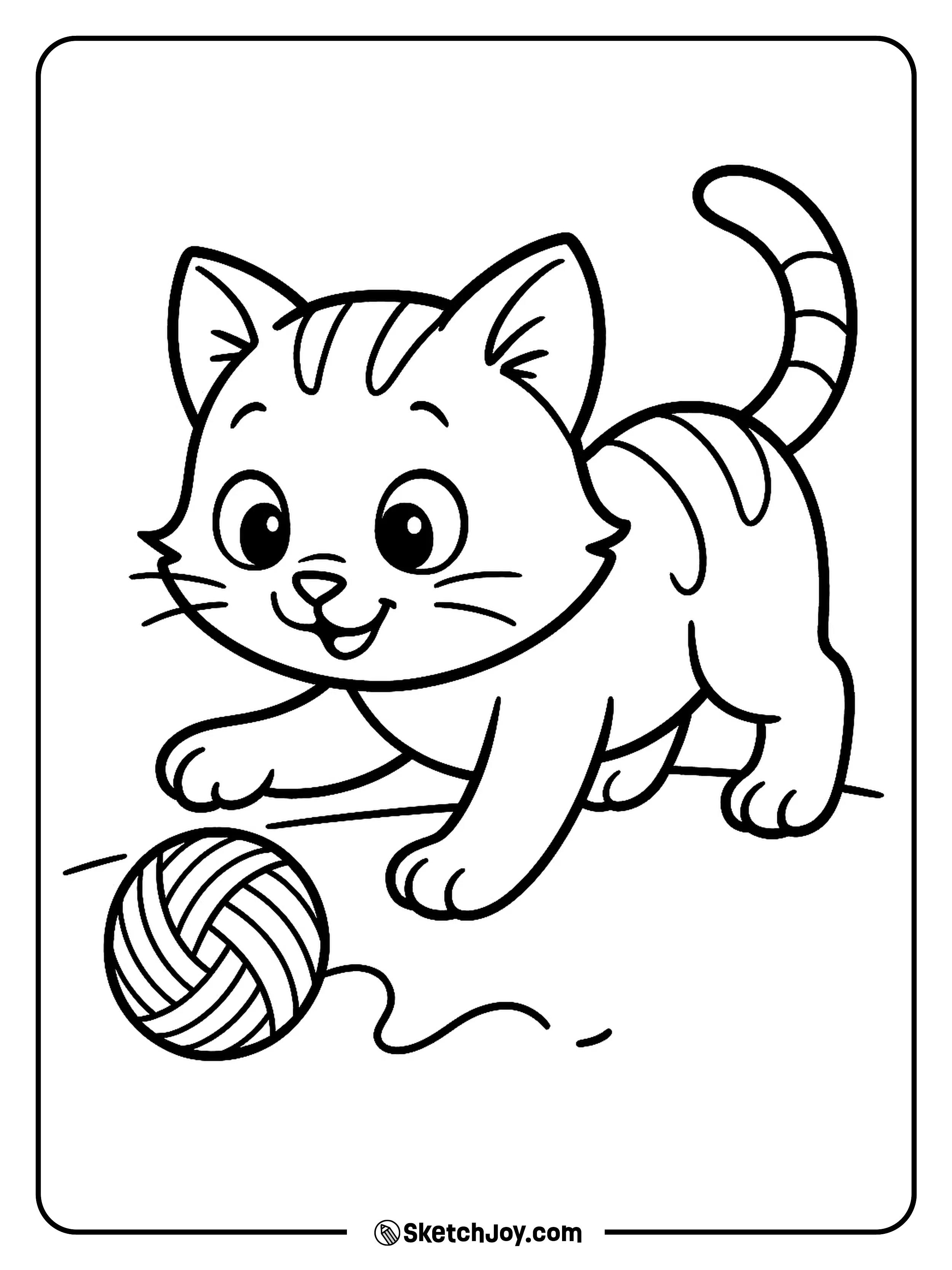 A playful kitten bats at a loose ball of yarn with a happy face.